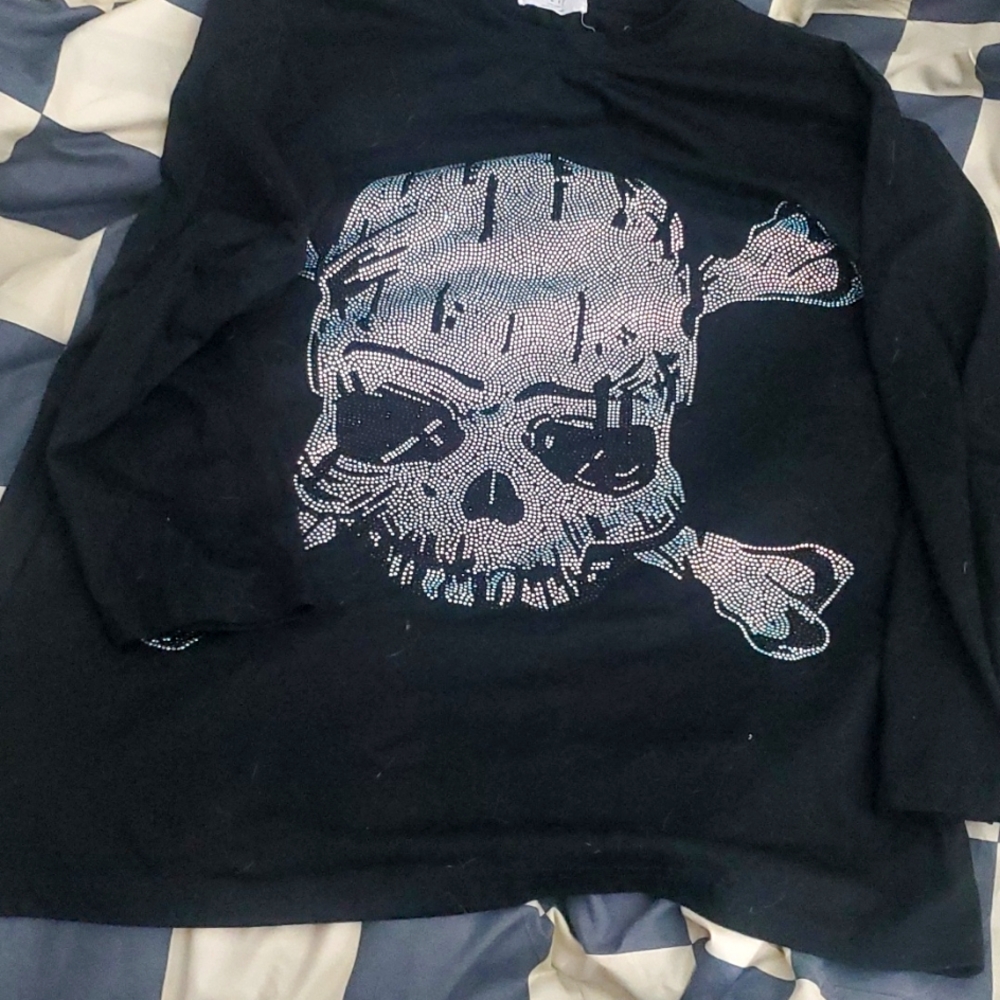 A large black, rinstone. Is a long sleeve and very comfortable.